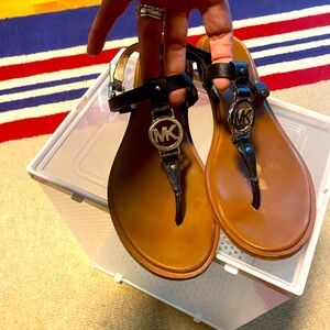 Black, flat, Michael Kors sandals. Size 10. Well-worn but still some life!